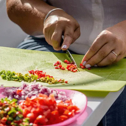 person preparing vegetables on a cutting board