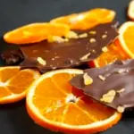 candied orange slices on a plate with chocolate