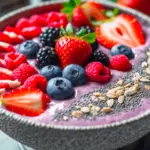 a pitaya bowl with fruit and nuts